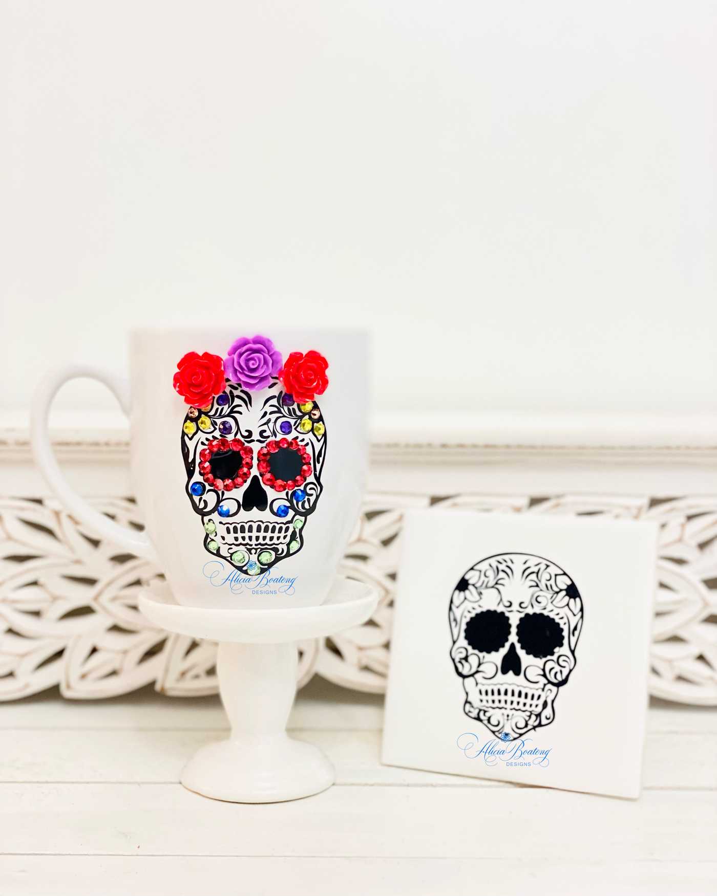 Beautifully decorated sugar skulls to celebrate el Dia de los Muertos. Adorned with colored gems, porcelain rosettes and adhesive vinyl.